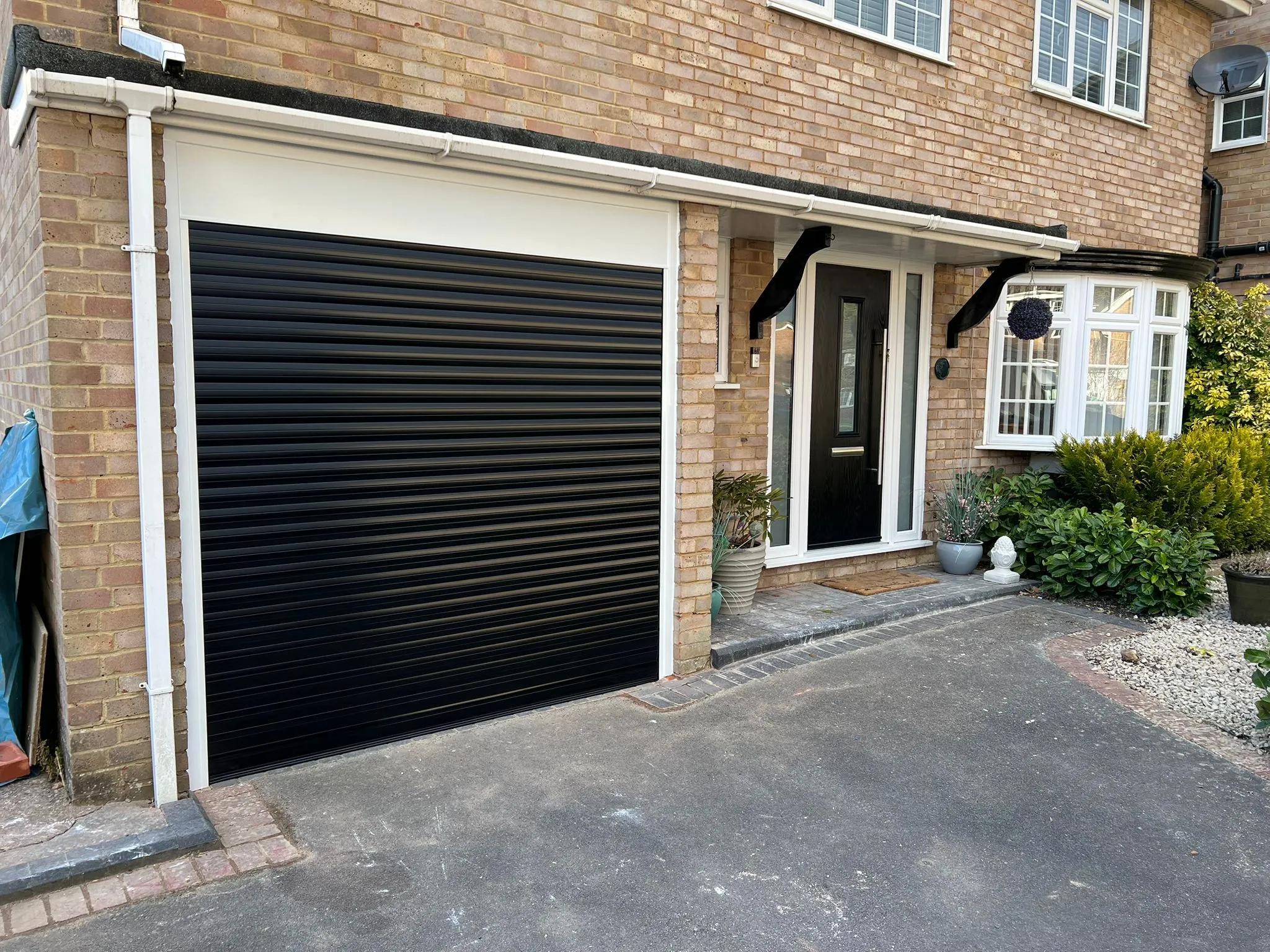 black striped garage door next to black door